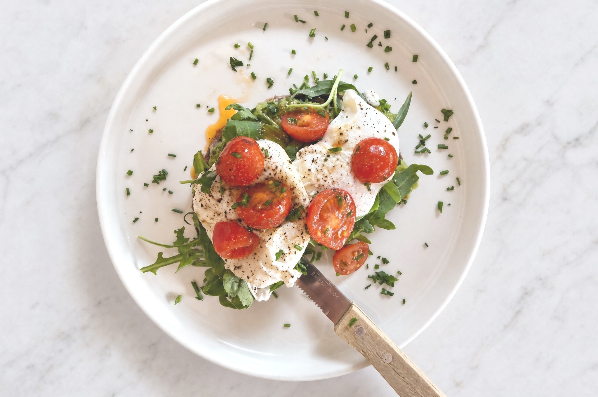 Sourdough sandwich with guacamole, two poached eggs and roasted cherry tomatoes — Café Miro